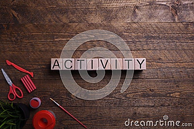 Word activity wooden cubes, blocks on the subject of education, development and training on a wooden background. Top view. Place Stock Photo