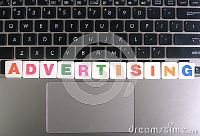Word Advertising on keyboard background Stock Photo