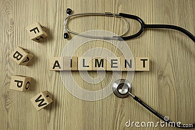 Word ailment from wooden blocks with stethoscope Stock Photo