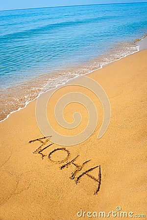 Word Aloha written in sandy on tropical beach Stock Photo