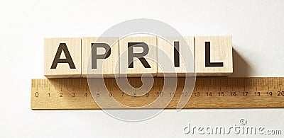 Word April made with wood building blocks Stock Photo
