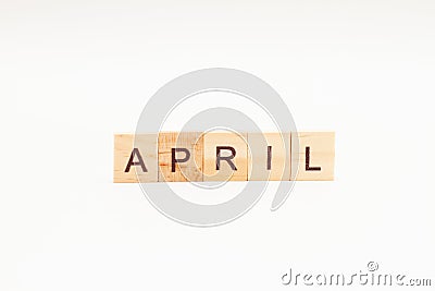 Word APRIL made of wooden blocks on white background. Month of year Stock Photo