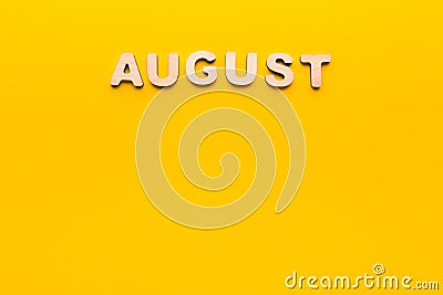 Word August on yellow background Stock Photo