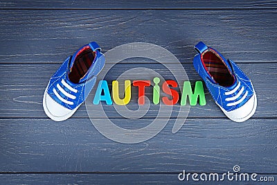 Word AUTISM with kids shoes Stock Photo