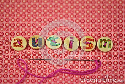 The word autism spelled with buttons with letters on Stock Photo