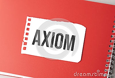 The word axiom on torn paper on red notepad Stock Photo