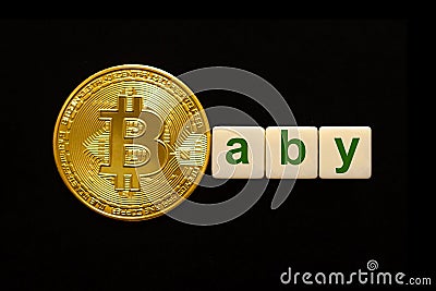 Word Baby made up of cubes. The first letter of the word is symbolized by a bitcoin coin. Stock Photo