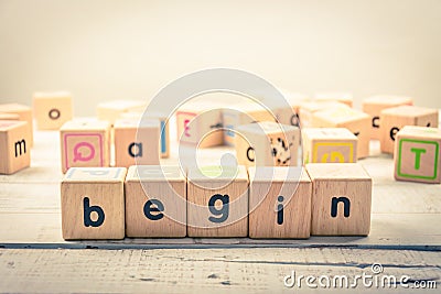 Word ` begin ` wood Cubic on the wood Stock Photo