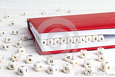 Word Bestseller written in wooden blocks in red notebook on whit Stock Photo