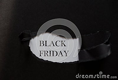 Word BLACK FRIDAY printed on a white background with black torn paper Stock Photo