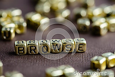Word BROWSE made from small golden letters on the brown background, selective focus Stock Photo