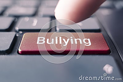 The word bullying on the computer keyboard. The concept of harassment intimidation and humiliation in the network Stock Photo