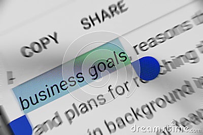 Word `business goals` selected and highlighted digitally on mobile display screen Stock Photo