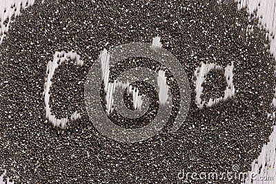 Word chia made from chia seeds on white wooden background. Healthy food. Stock Photo