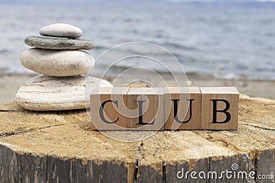 The word club from wooden cubes. The cubes are on the tree stump Stock Photo