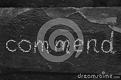 The word commend written with chalk on black stone. Stock Photo