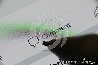 The word `Comment` highlighted with icon on digital mobile device Stock Photo