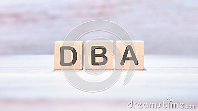 Word DBA (Database administrator) on wooden cubes on an abstract background Stock Photo