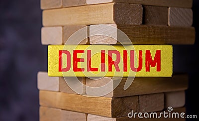 word delirium made of wooden letters on a gray table on a green background Stock Photo