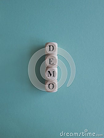 The word Demo on wooden cubes. Blue background. An extensive concept of the word demo applied in different fields of activity. Stock Photo