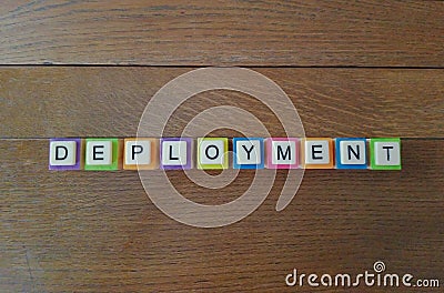 Word deployment on wood background with bright colors. Stock Photo