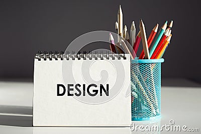 The word Design written on notebook on colorful pencil background Stock Photo