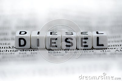 Word DIESEL formed by wood alphabet blocks on newspaper Stock Photo