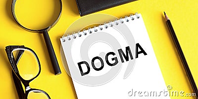 Word dogma printed on white notepad on office table Stock Photo