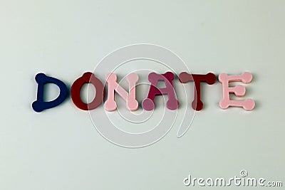 The word Donate formed with colorful felt letters Stock Photo