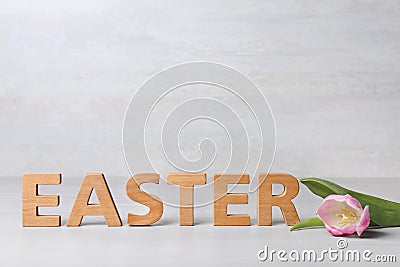 Word EASTER made of wooden letters and spring tulip Stock Photo