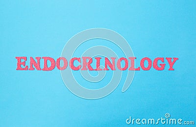 The word endocrinology on a blue background. The concept of the section of medicine dealing with the treatment of diseases of the Stock Photo