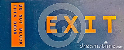 exit door signage in rescue orange color emergency door procedures Stock Photo