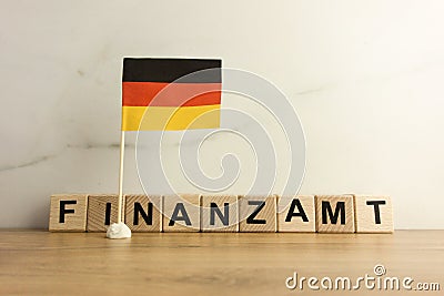 Word finanzamt which means tax office in German and flag of Germany Stock Photo