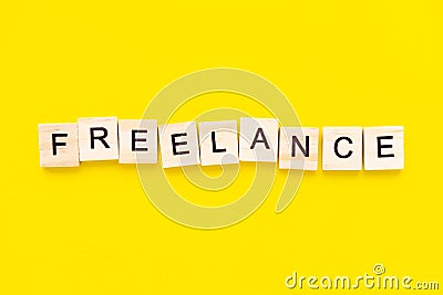 Word freelance. Wooden blocks with lettering on top of yellow background. Human Resource Management and Recruitment and Stock Photo