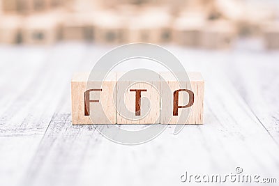 The Word FTP Formed By Wooden Blocks On A White Table Stock Photo