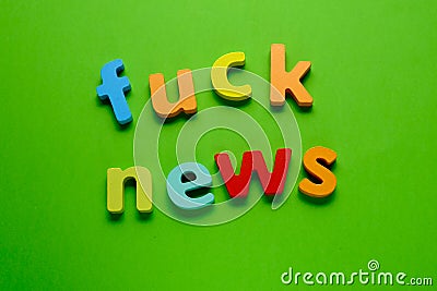 Word FUCK NEWS on green background. Learning the English alphabet and language.The concept of education, school, kindergarten Stock Photo