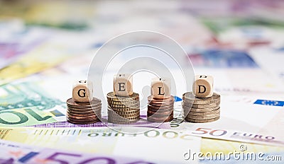 Word Geld on coin stacks, cash background Stock Photo