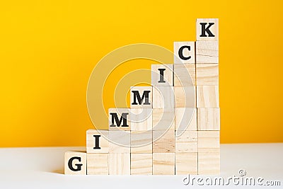 the word gimmick is written on a wooden cubes, concept Stock Photo