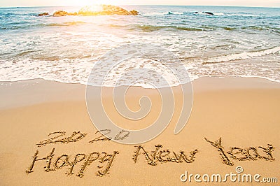 Write 2020 happy new year on beach Stock Photo