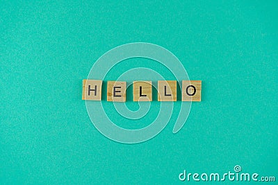 Word hello. The phrase is laid out in wooden letters. Top view. Motivation. Blue background. Copy space Stock Photo