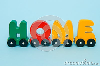 Word Home made of letters train cars alphabet. Bright colors of red yellow green and blue on a white background. Early childhood e Stock Photo