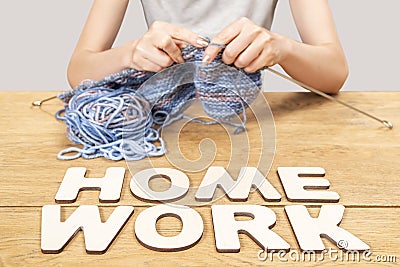 Word homework and knitting woman Stock Photo