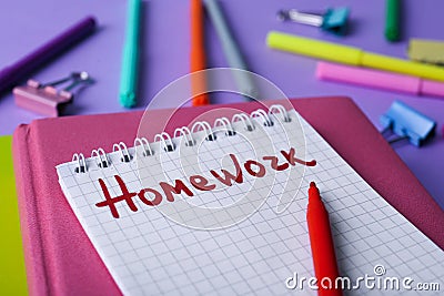 Word HOMEWORK in notebook on violet table Stock Photo