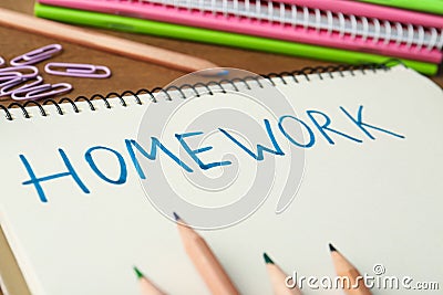 Word HOMEWORK written in notebook on table, closeup Stock Photo