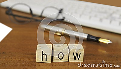 The word how on wood stamp Stock Photo