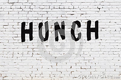 Word hunch painted on white brick wall Stock Photo