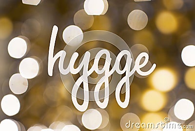 Word hygge over blurred golden lights background Stock Photo