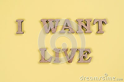 Word I want live abstract wooden letters, yellow background. Stock Photo