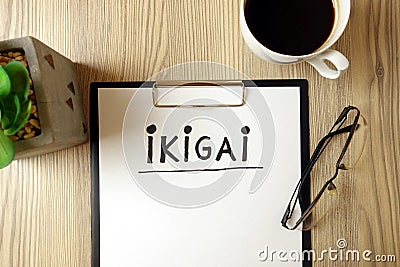 Word ikigai handwritten in notepad with accessories Stock Photo