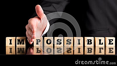 The word Im - Possible on wooden blocks Stock Photo